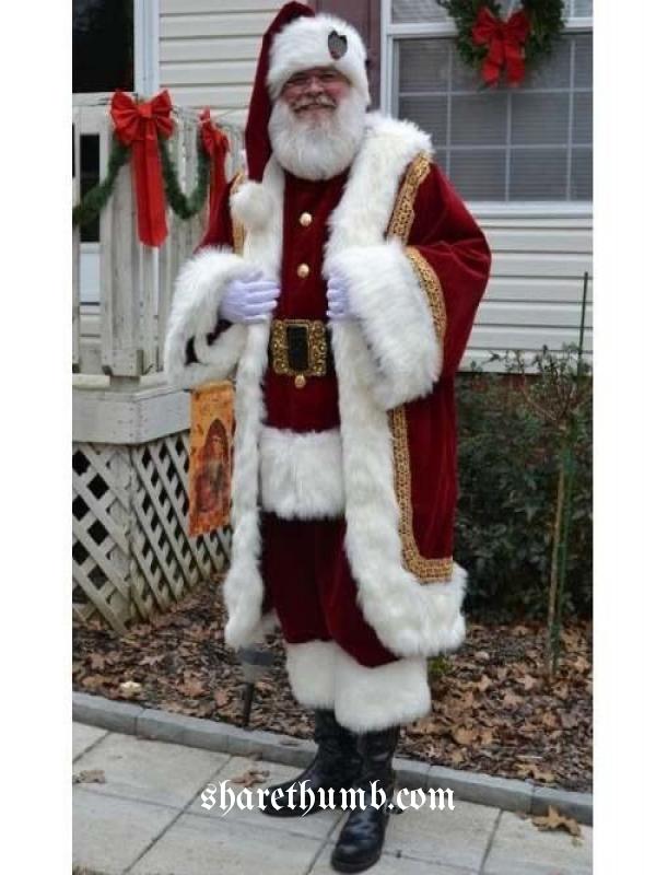 Man wear the santa dress and stand in front of house